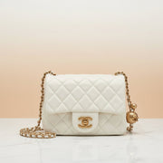 Chanel Pearl Crush mini square flap bag in quilted lambskin with CC turnlock, pearl charm and chain strap